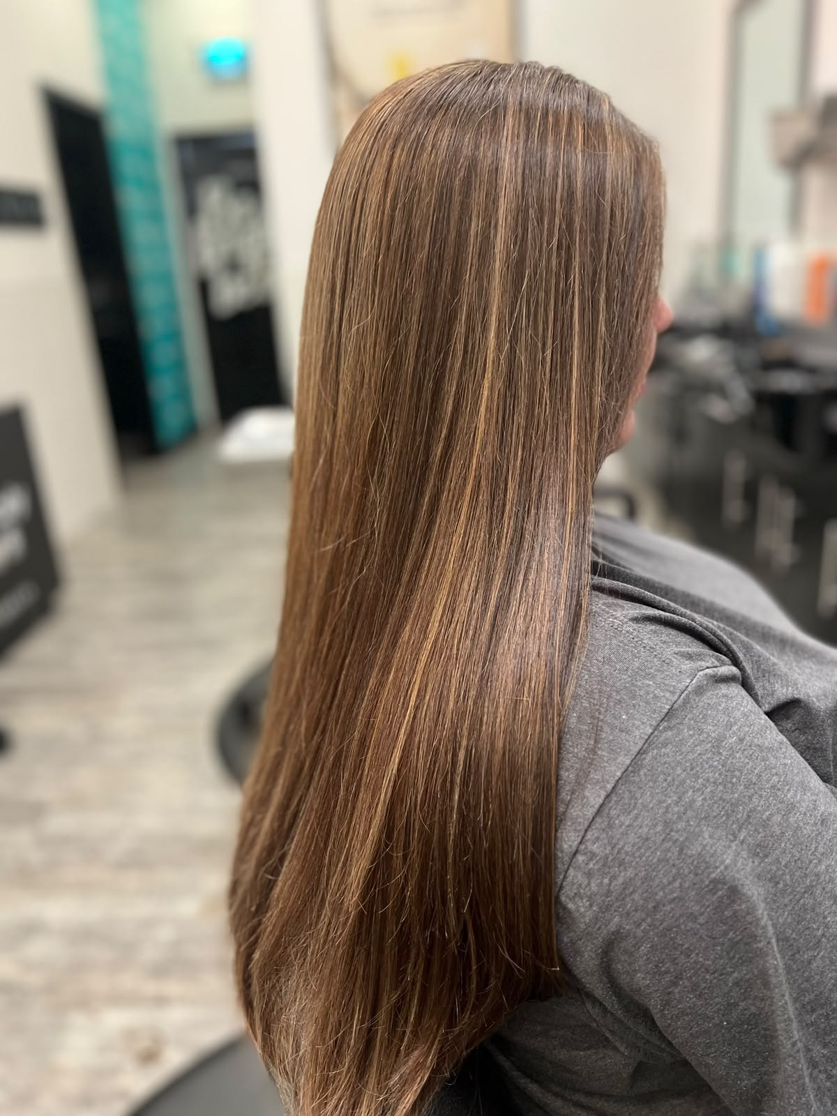Sleek brunette lengths by Kelly May at Shear Bliss
